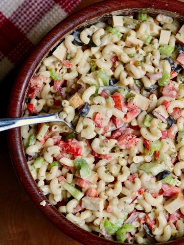 vegan macaroni salad in a wooden bowl with a spoon