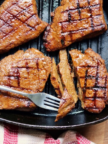 overhead view vegan steak sliced in a grill pan