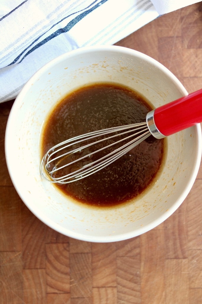 asian salad dressing in a small bowl with a whisk