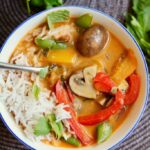 vegan thai red curry vegetables Iin a white bowl with rice