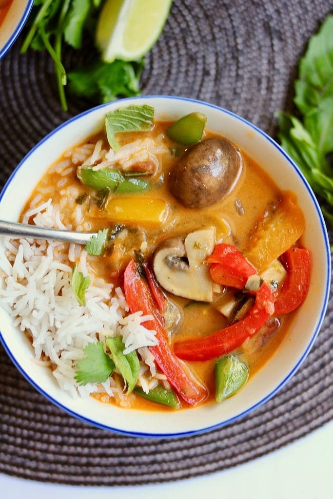 vegan thai red curry vegetables in a white bowl with rice