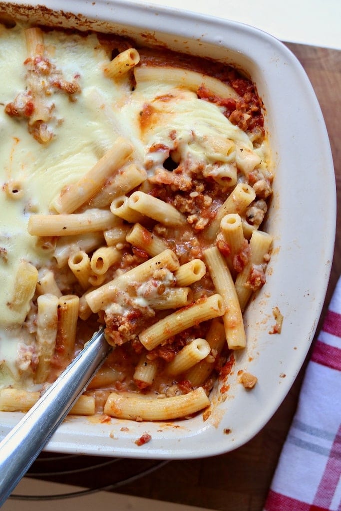 vegan baked ziti in a casserole dish with serving spoon