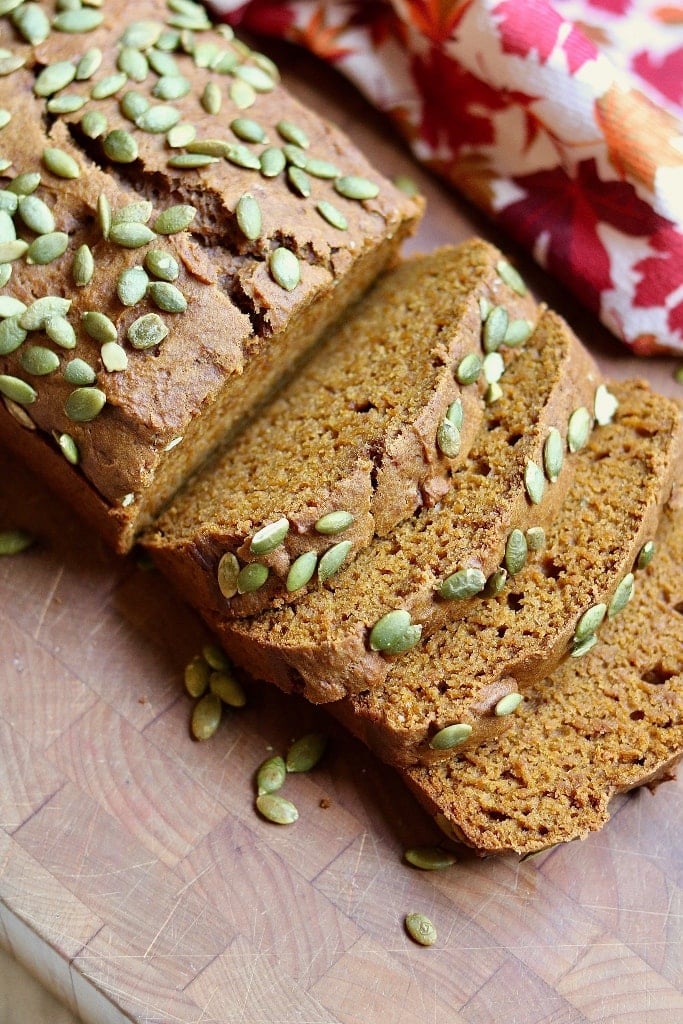 four slices of vegan pumpkin bread on a cutting board