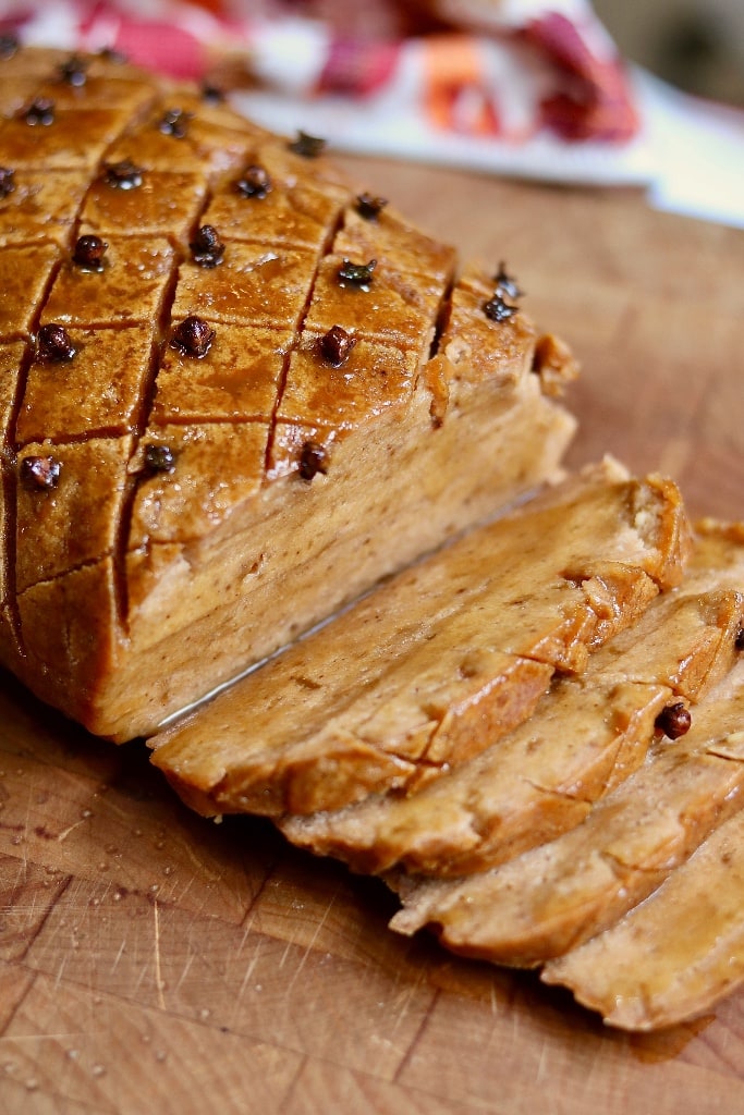 vegan ham sliced on cutting board