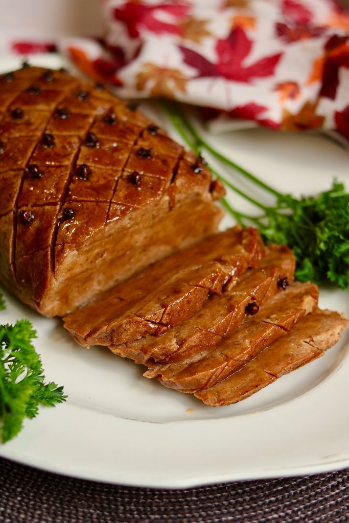 seitan ham sliced on a serving plate