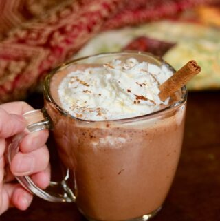 a cup of vegan hot chocolate with coconut whipped cream