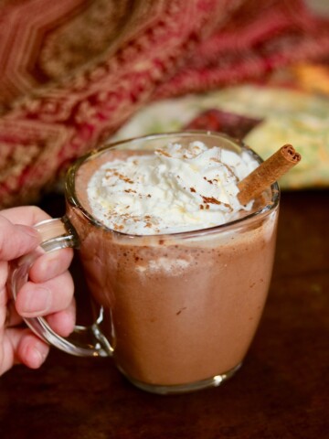 a cup of vegan hot chocolate with coconut whipped cream