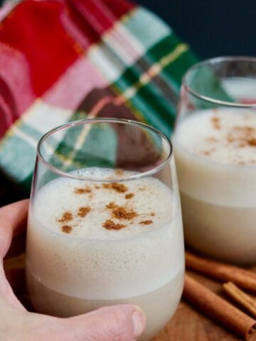 a glass of eggnog being held