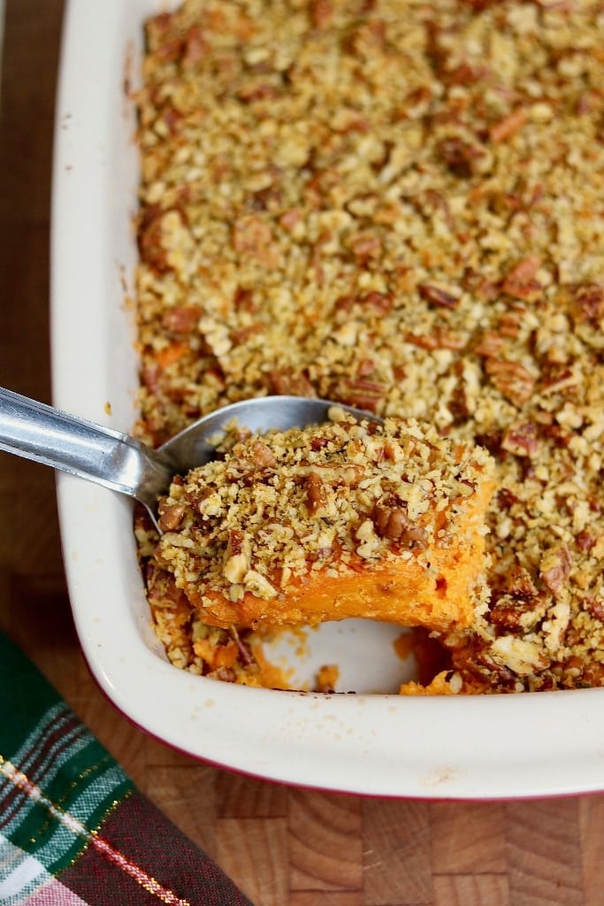 vegan sweet potato casserole being dished out with serving spoon