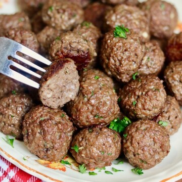 vegan meatballs on a platter with a fork