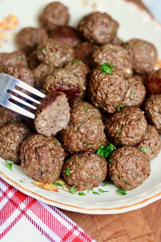 vegan meatballs on a platter with a fork