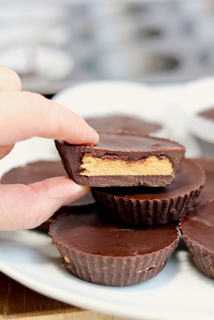 peanut butter cup sliced in half and stacked on a plate