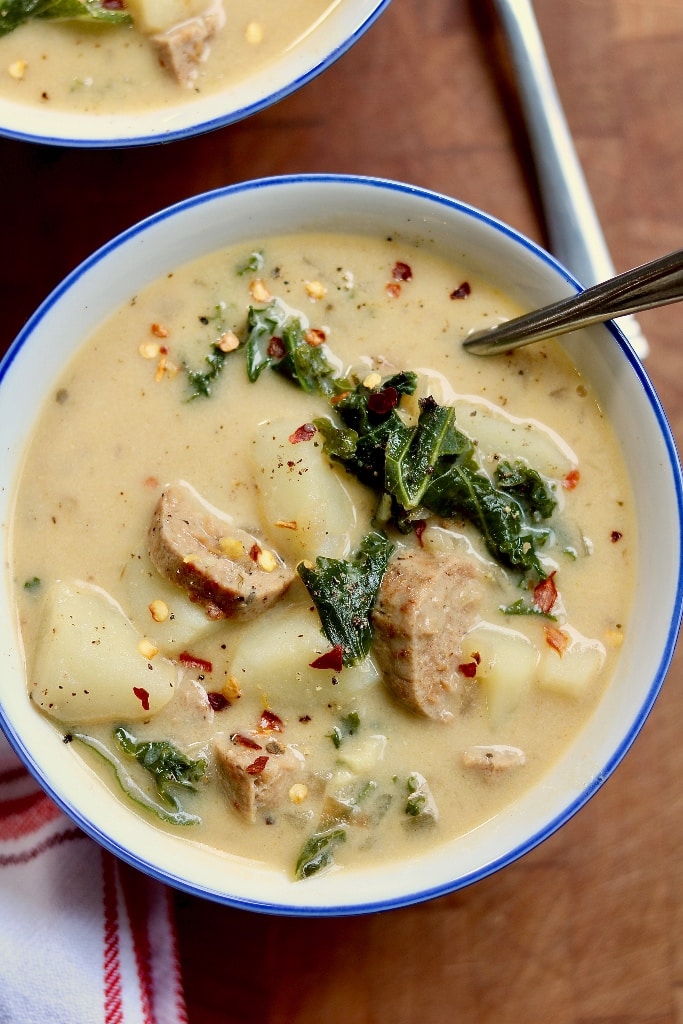 vegan zuppa toscana in a bowl with a spoon