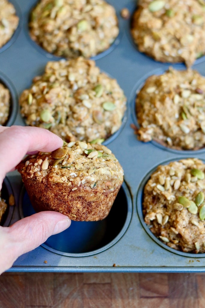 freshly baked muffins being taken out of pan
