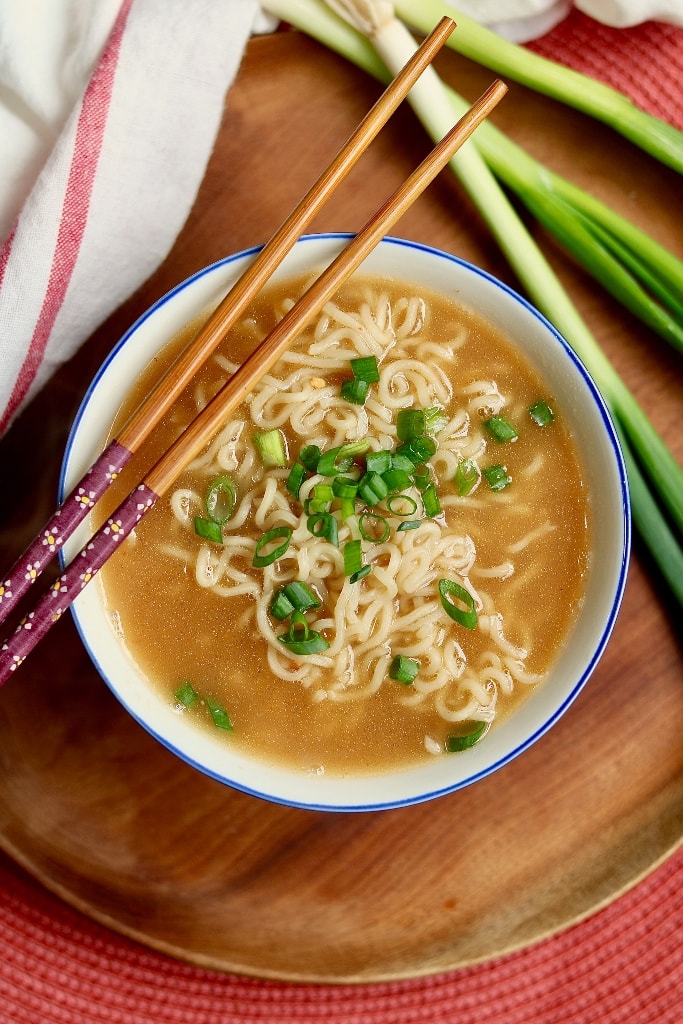 vegan ramen in a white bowl with chopsticks