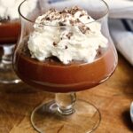 vegan chocolate pudding in a dessert cup with coconut whipped cream