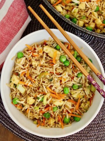 vegan fried rice in a bowl with chopsticks