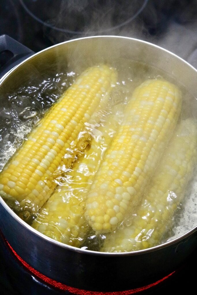 corn on the cob boiling in a pot