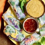 fresh spring rolls on serving platter with thai peanut sauce and Nuoc Cham