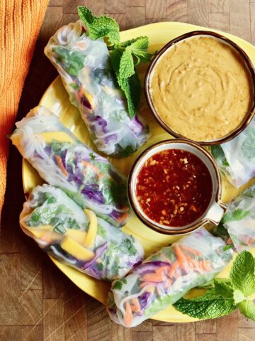 fresh spring rolls on serving platter with thai peanut sauce and Nuoc Cham