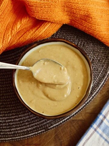 peanut sauce in a dip bowl with a spoon