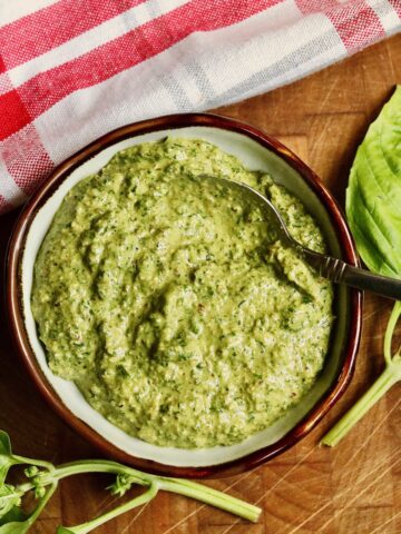 vegan pesto in a bowl with a spoon ready to serve