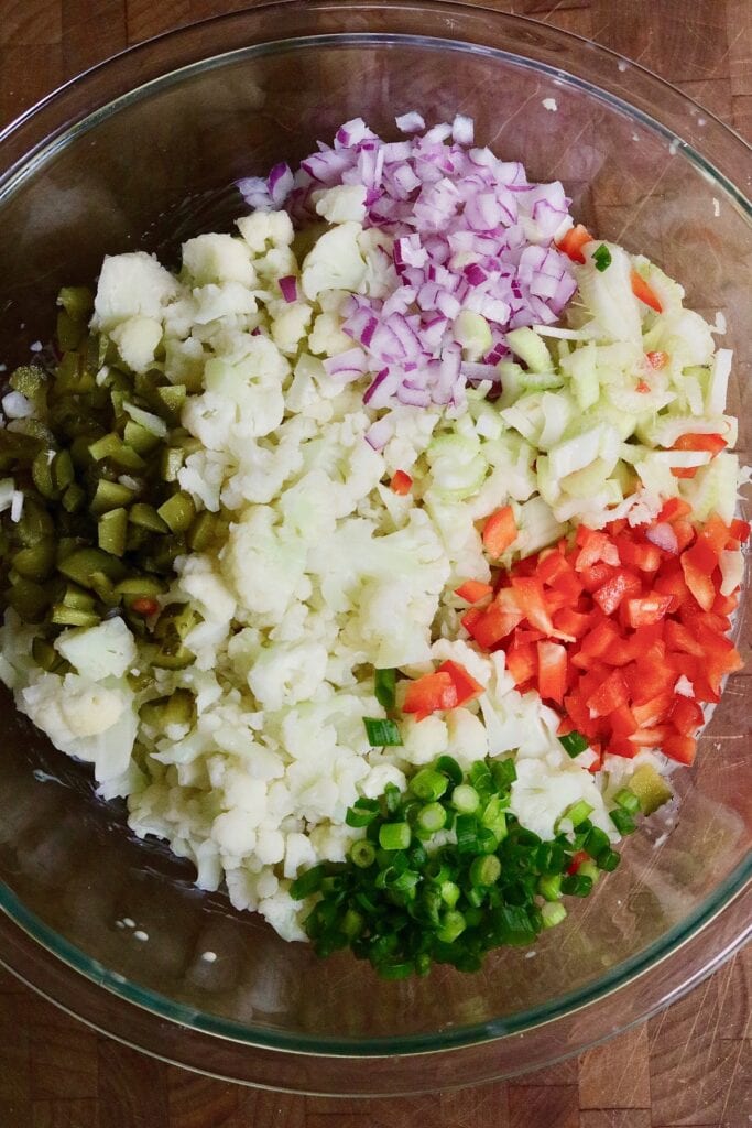 keto cauliflower potato salad ingredients in a mixing bowl
