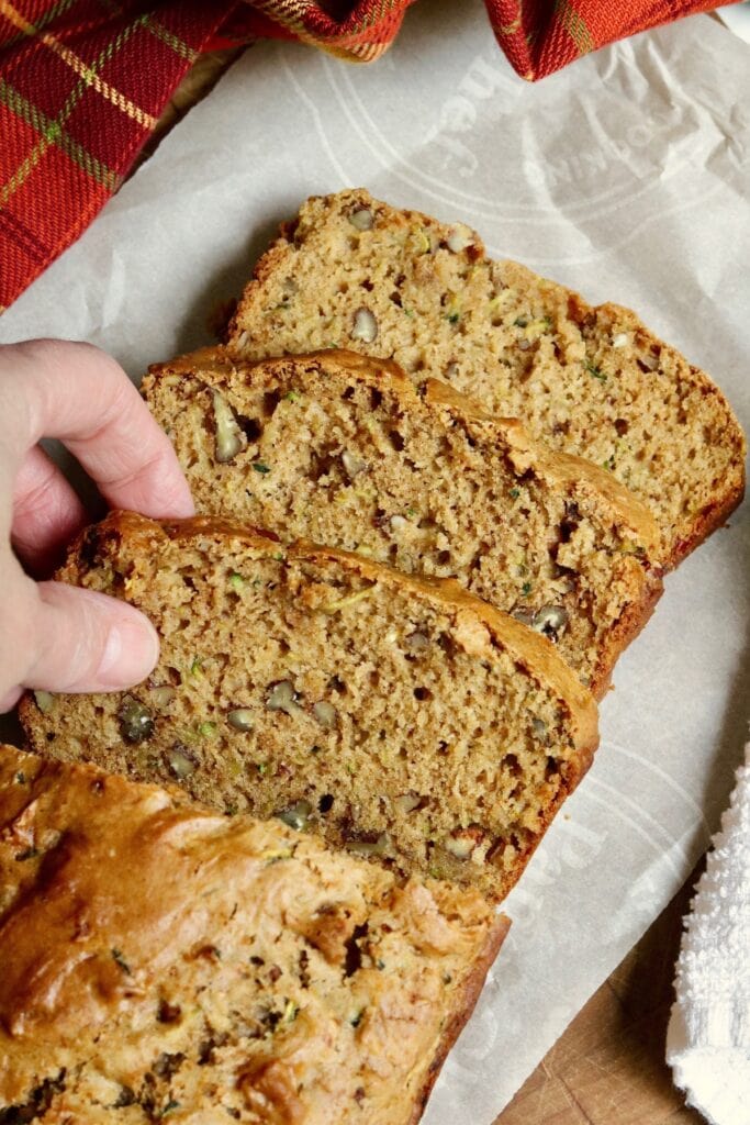 slice of vegan zucchini bread being picked up from a breakfast tray