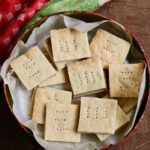 overhead view of vegan shortbread cookies in a holiday cookie tin