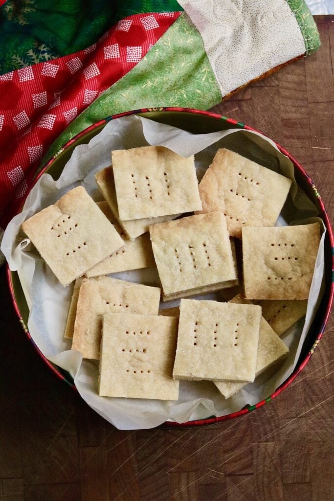 overhead view of vegan shortbread cookies in a holiday cookie tin