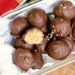 chocolate peanut butter balls in a holiday container ready to serve
