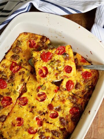a slice of vegan breakfast casserole being served from dish