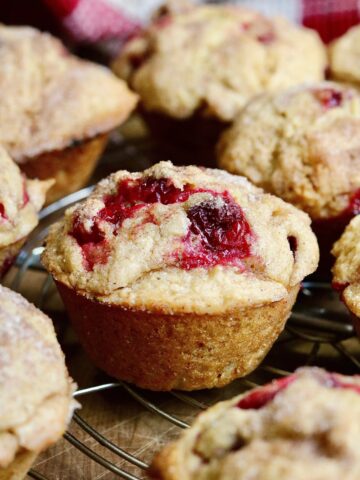 close up of vegan cranberry muffins baked and cooling on wire rack