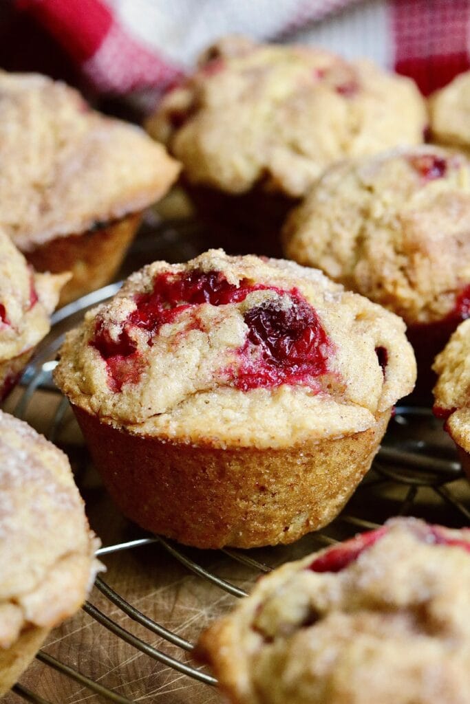 close up of vegan cranberry muffins baked and cooling on wire rack