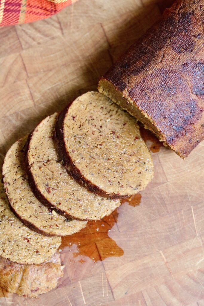 overhead view of partially sliced seitan beef roast