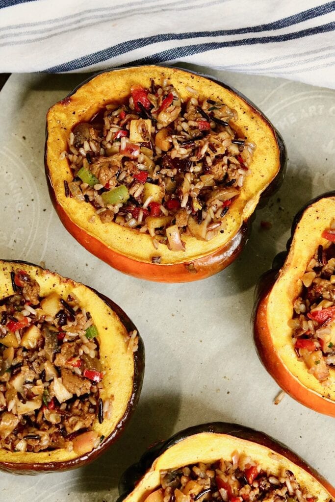 overhead view of stuffed acorn squash baked on a sheet pan