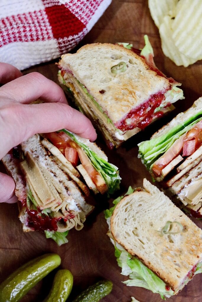 overhead view of vegan club sandwich cut into four triangles