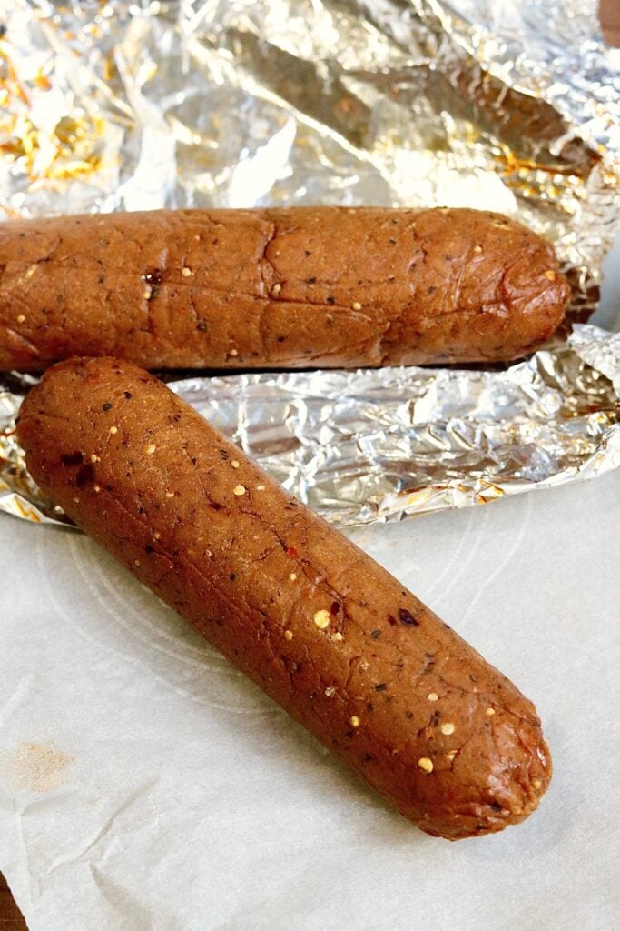 two vegan pepperoni logs cooked and ready to slice