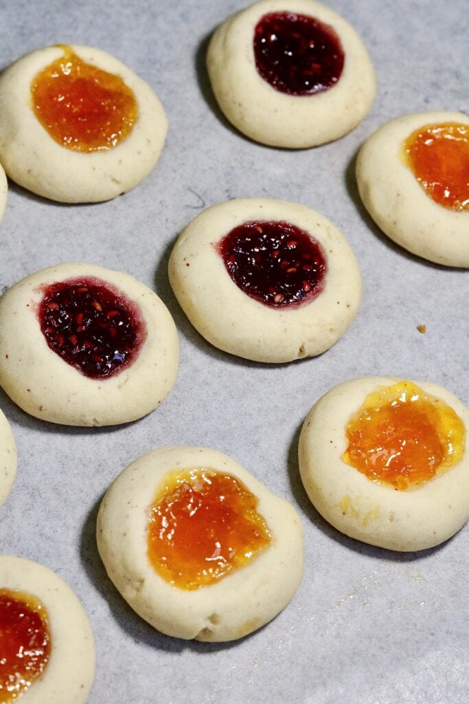thumbprint cookies baked on a cookie sheet