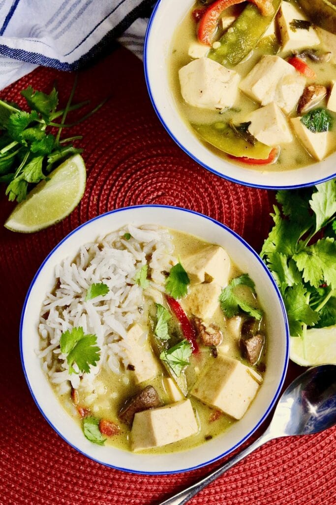 a bowl of tofu thai green curry and rice in a bowl