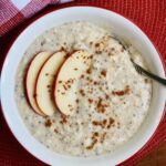 apple cinnamon overnight oats in a bowl with apple slices on top