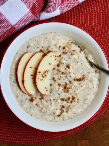 apple cinnamon overnight oats in a bowl with apple slices on top