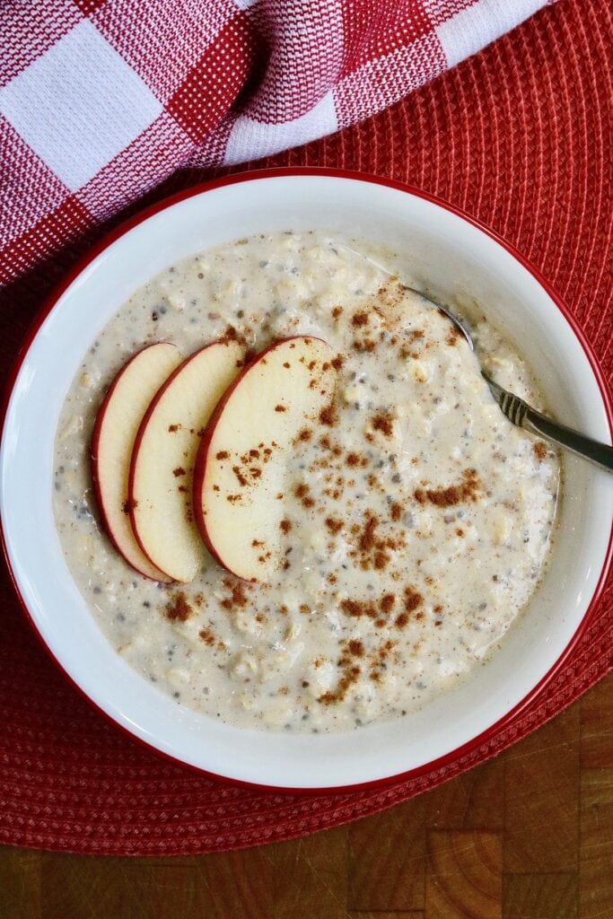 apple cinnamon overnight oats in a bowl with apple slices on top