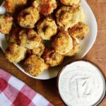 air fryer breaded mushrooms on a plate with vegan ranch dressing
