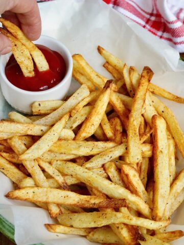 a plate of air fryer French fries with ketchup