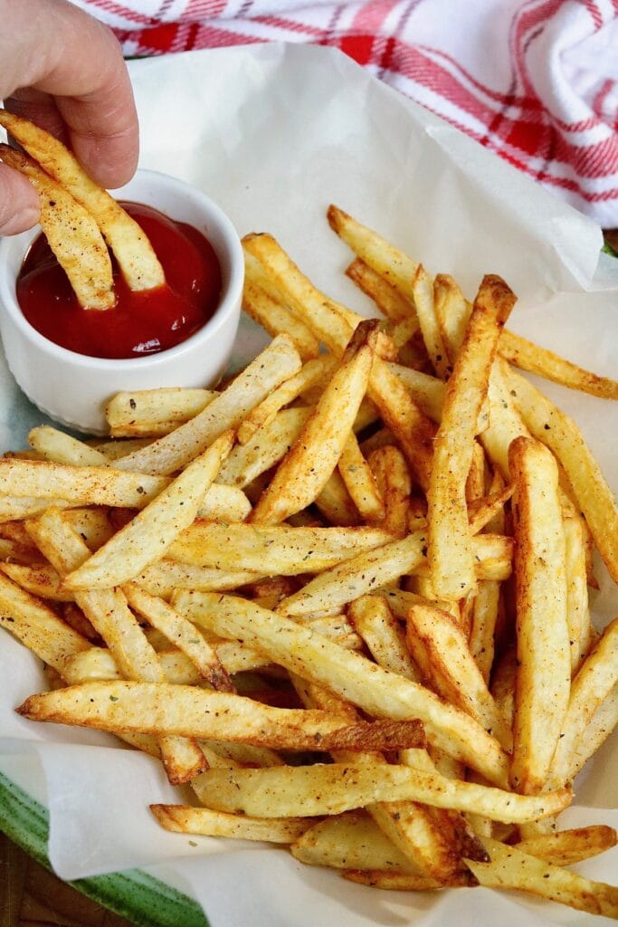 a plate of crispy air fryer French fries with ketchup