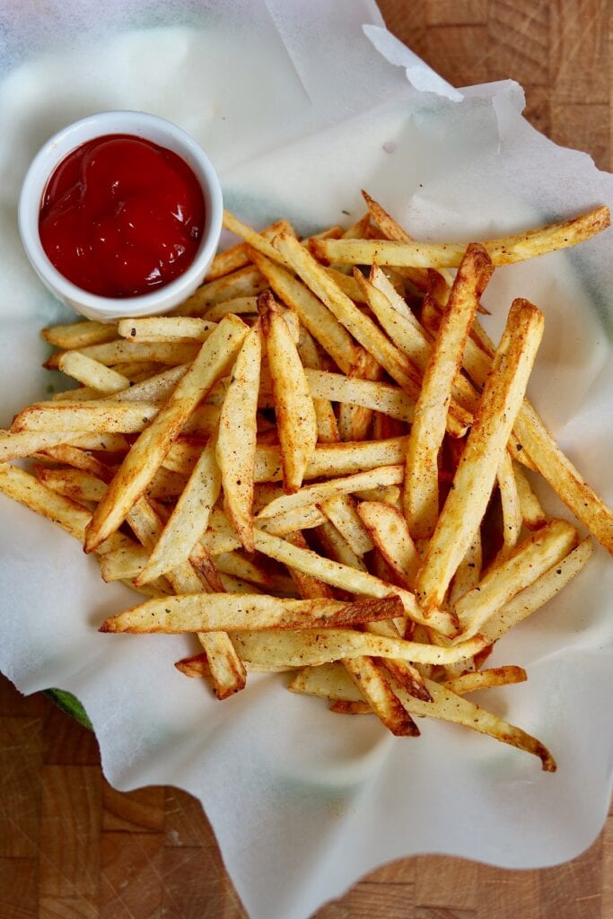fries on a plate with ketchup