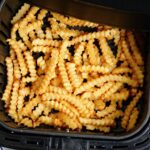 overhead view frozen french fries cooked in an air fryer