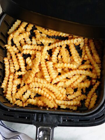 overhead view frozen french fries cooked in an air fryer