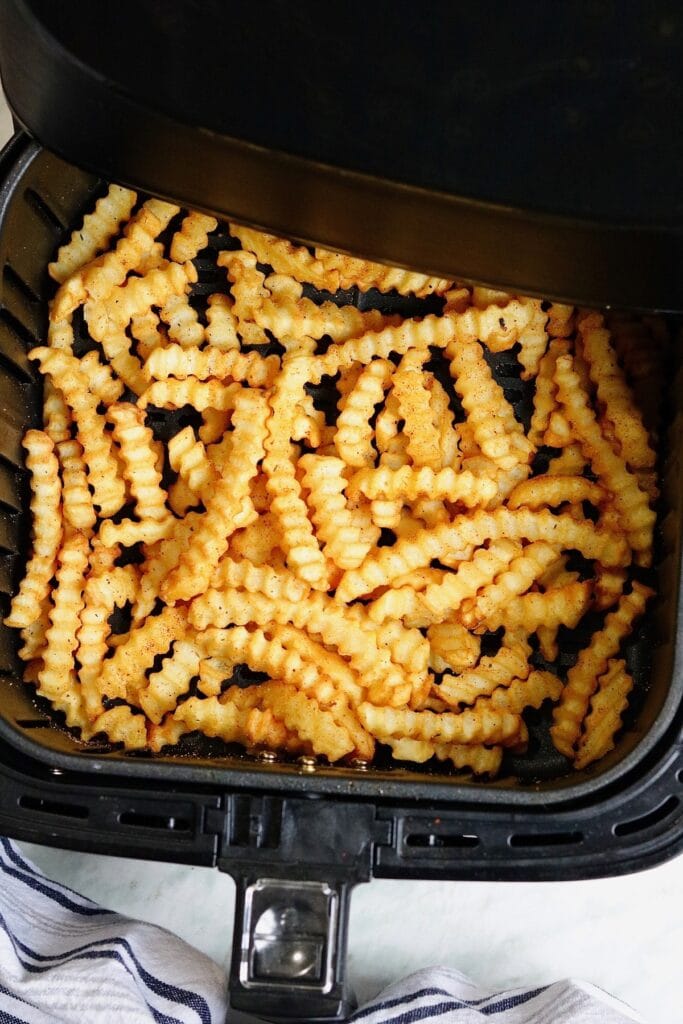 overhead view frozen french fries cooked in an air fryer 